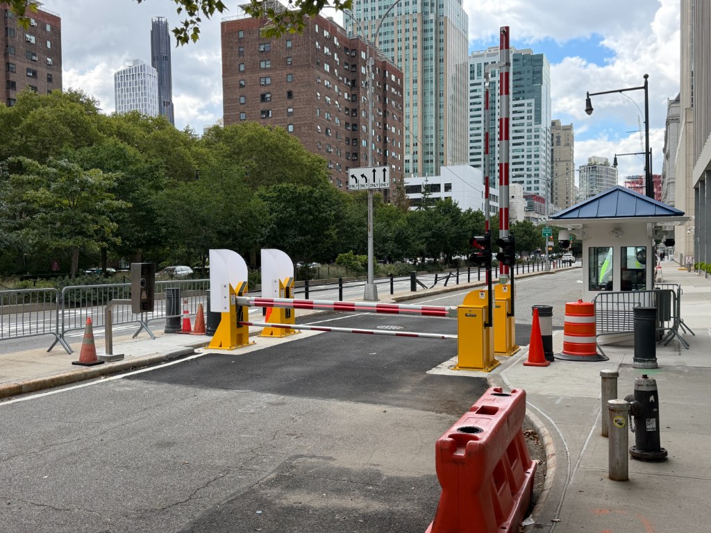 Barrier arm gate controlling vehicle access