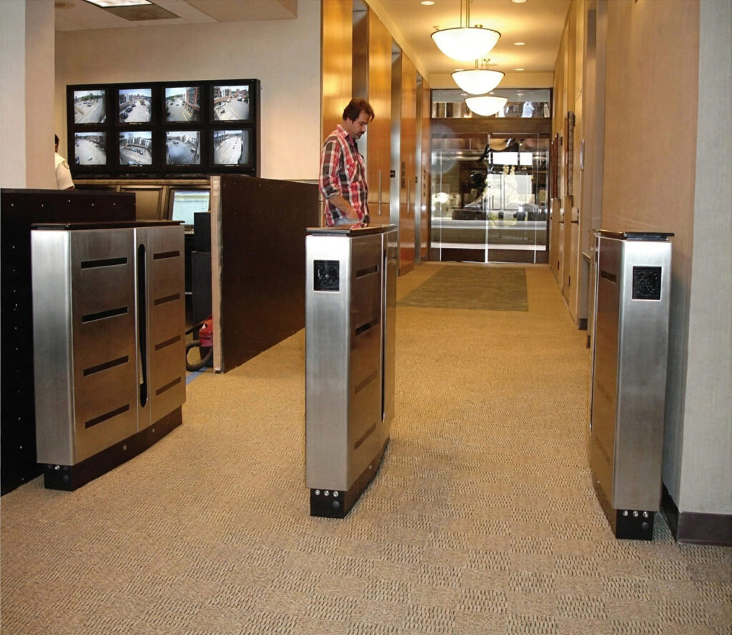 Optical turnstile installation providing controlled pedestrian entry within a commercial building lobby.